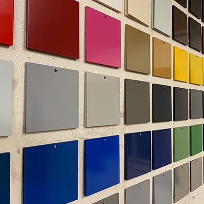 Powder coating colour chips hanging on a wall